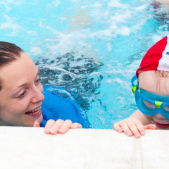 Teacher and swimmer, one-to-one, poolside